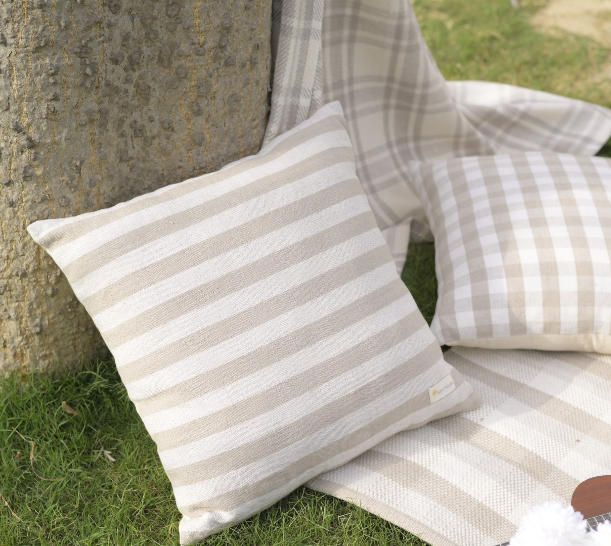 Muted clay tone cushion covers on timber bench