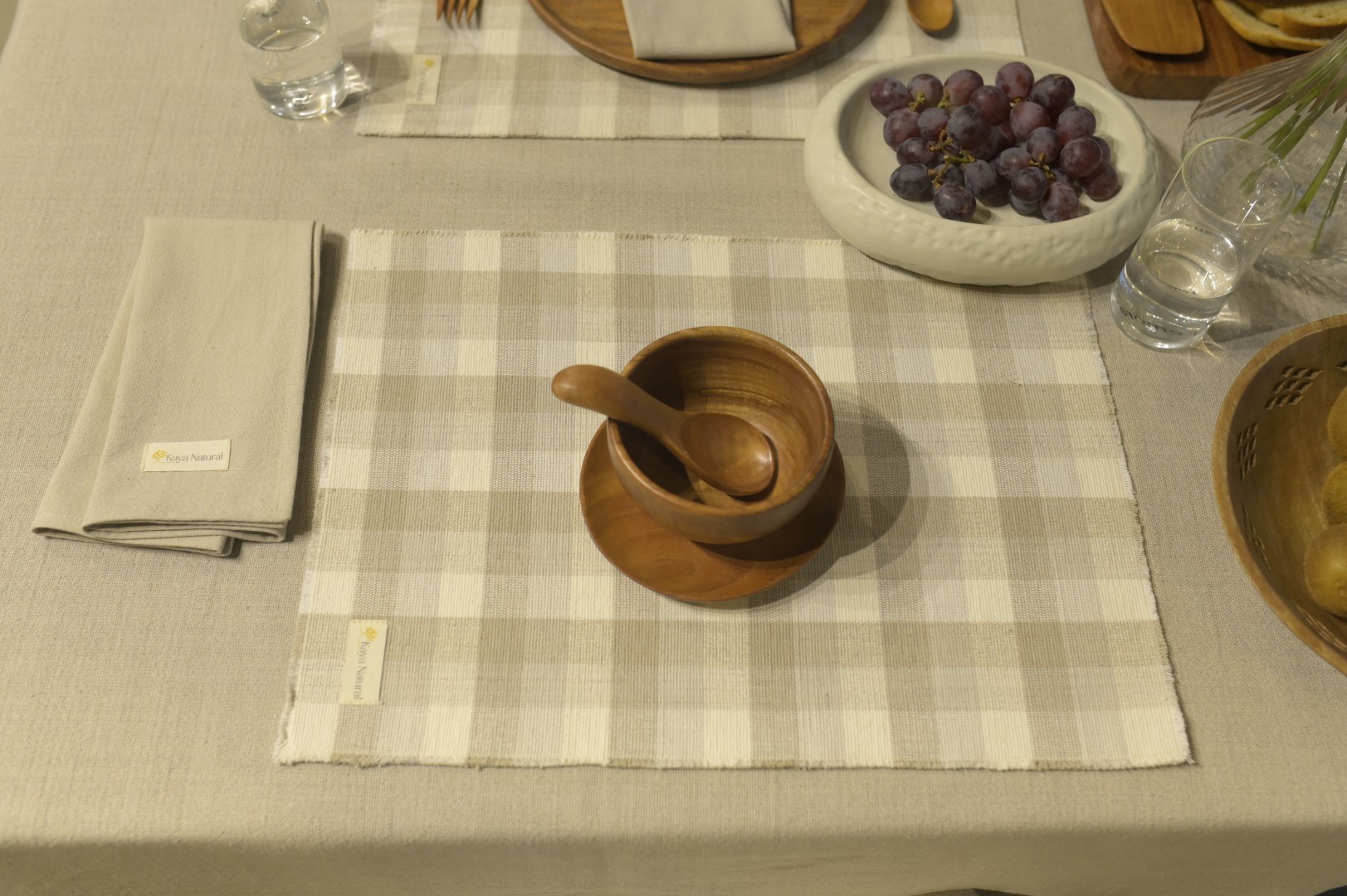 Muted clay tone cushion covers on timber bench